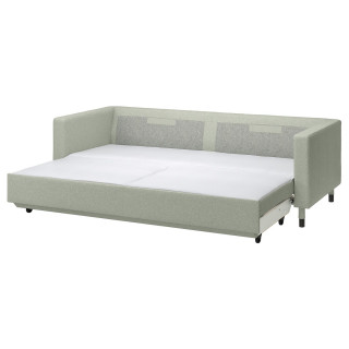 Jasnozielona rozkładana sofa, solidne dębowe nogi, twarde poduszki, przekształca się w łóżko.